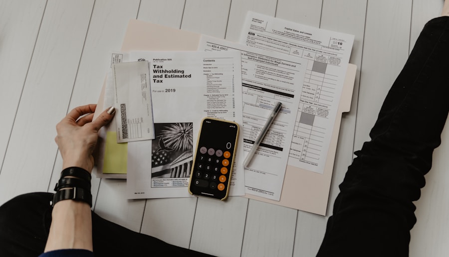 Restaurant financial documents with tax forms, calculator, and bookkeeping paperwork on a desk