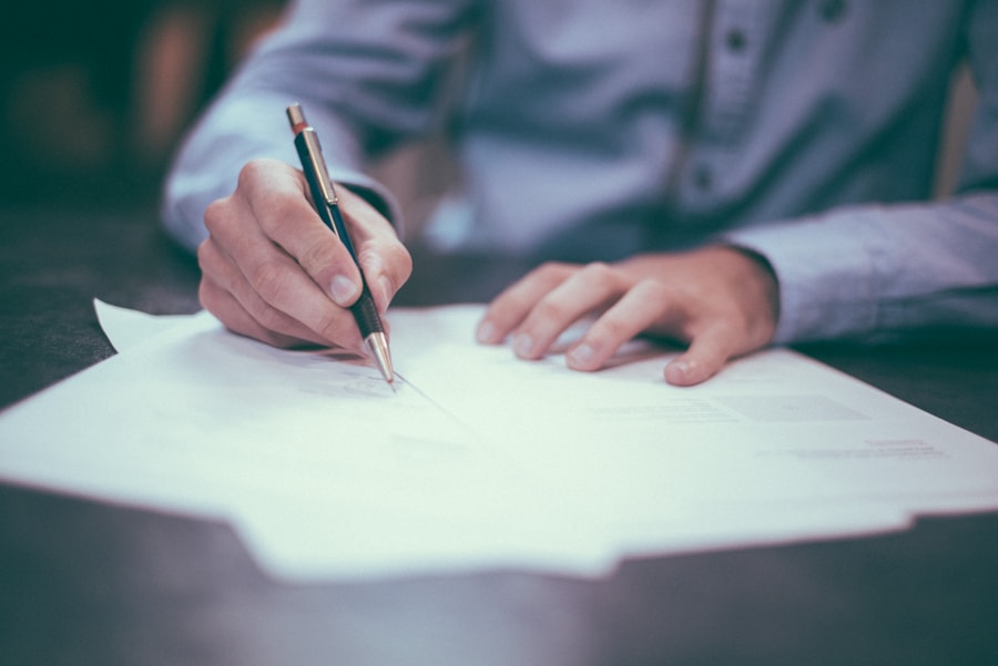 Restaurant manager reviewing financial spreadsheets and signing business documents